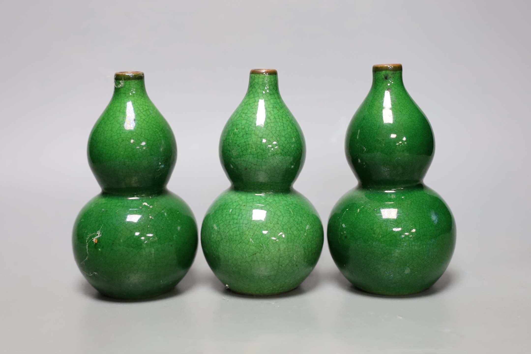 Three Chinese green crackle glazed double gourd vases, 15cm